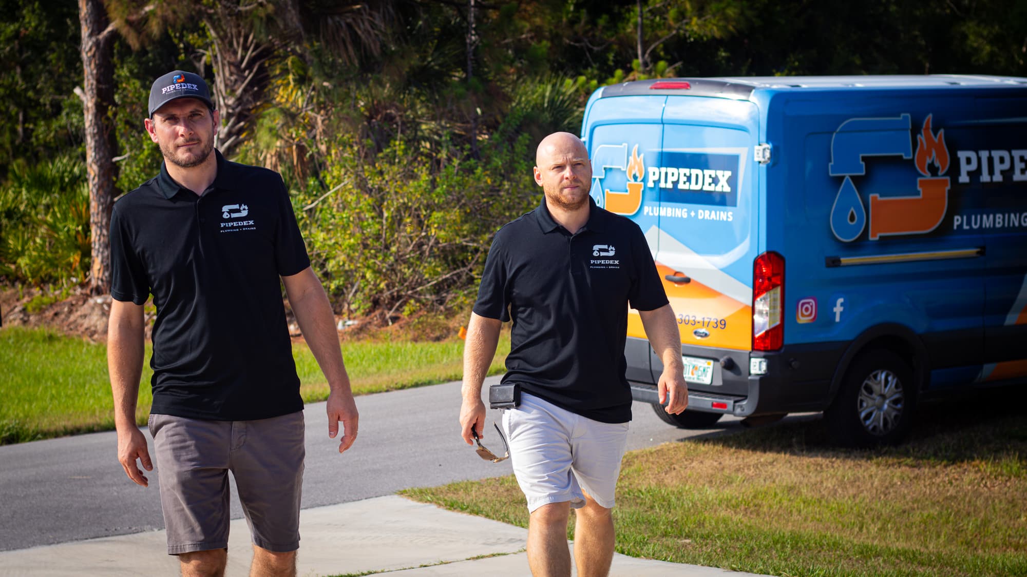 Pipedex plumbers walking up to a Southwest Florida home