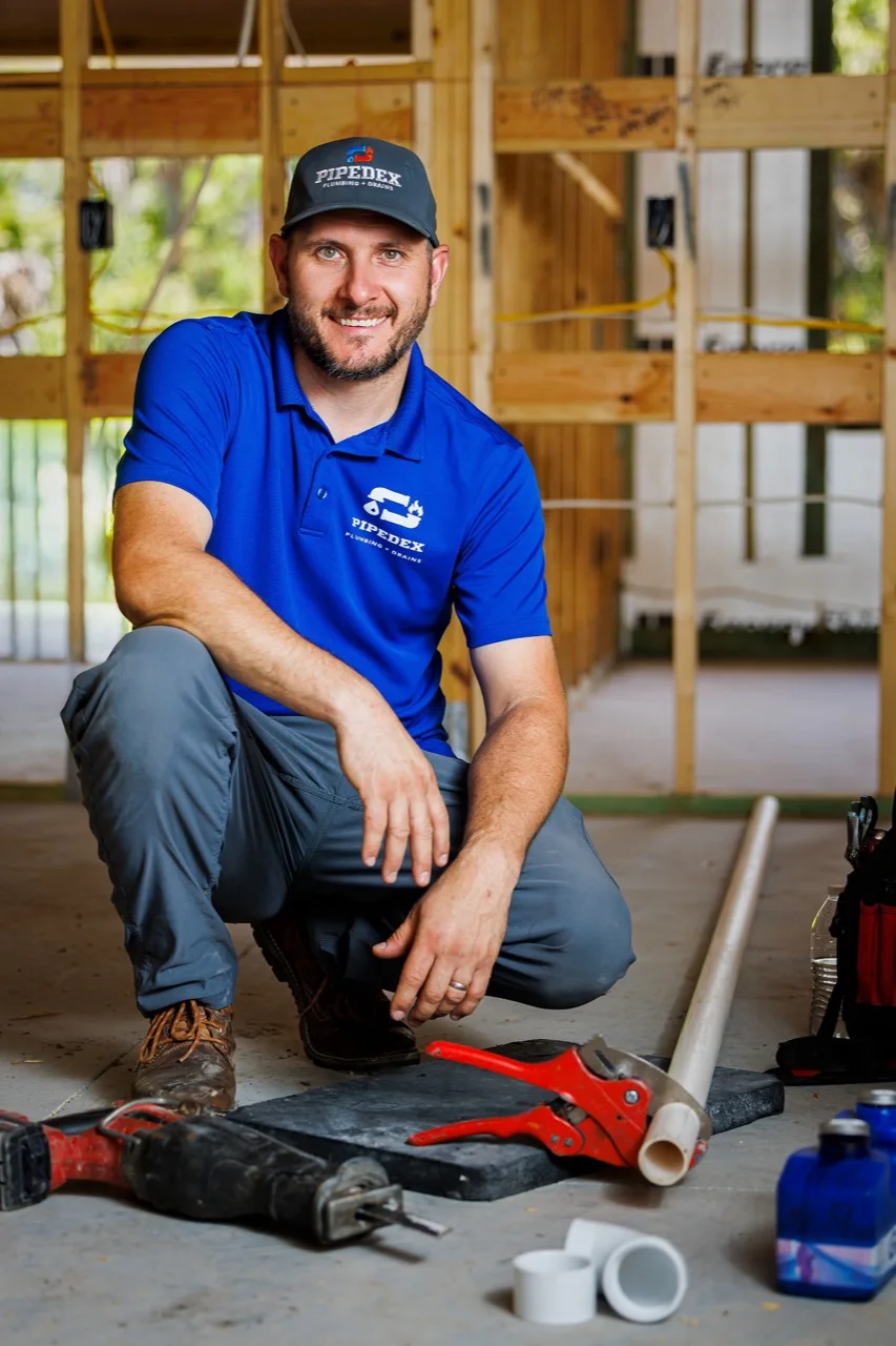 A Pipedex technician at a plumbing job site